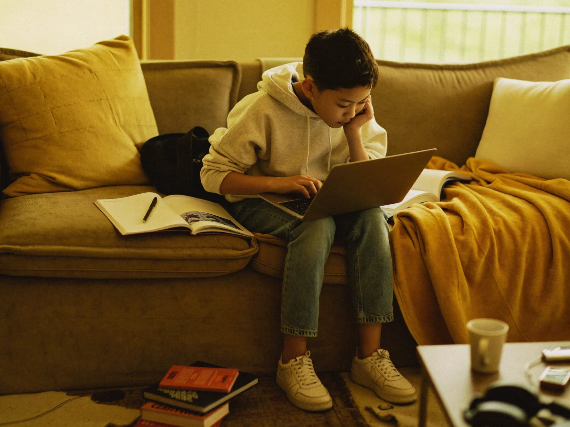 A student studying at a kitchen table